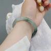 Librito rojo con patio de bambú verde de vidrio imitación Jade pulsera redonda pulsera gruesa con cascabel ropa Han antigua una generación de cabello