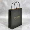 Bolsa de Tote de Papel Kraft Personalizada con Impresión de Logo Fabricante Venta al por Mayor Bolsa de Regalo Negra Mate Bolsa de Compras Hecha a Medida con Impresión