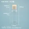Botella redonda de hombros lisos con tapa abatible tipo mariposa de 80 ml, botella de plástico PET, botella dispensadora de líquidos, botella de plástico transparente