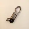 Llavero de coche de alta gama puede ser radiación láser llavero para hombre de negocios anti-pérdida hebilla de llave pequeños regalos al por mayor