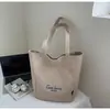 Bolsa de mano tipo tote simple de estilo coreano al por mayor para mujer 2025 Verano Nuevo Gran Capacidad Hombro Único Lona Versátil Bolso de Axila