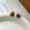 Brincos de Pedra Olho de Tigre Estilo Retro Hong Kong Outono Inverno para Mulheres 2026 Novos Brincos de Alto Padrão Únicos Design de Nicho Joias de Orelha