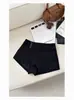 Shorts de lana con botones negros para mujer, nuevo estilo otoño e invierno, de cintura alta, adelgazantes, versátiles, línea A, casual, ajustados a la cadera, tipo bootcut