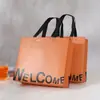 Bolsa No Tejida Laminada Personalizada Engrosada Nueva Empaque de Ropa Compras Regalo Tienda de Ropa para Mujer Bolso de Mano Personalizado