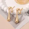Europa y Estados Unidos aretes transfronterizos de personalidad exagerada doble flor de cinco pétalos simples retro hojas rayadas aretes con borla al por mayor