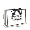 Bolsa de regalo de boda exclusiva transfronteriza para el Equipo de la Novia con lazo de cinta blanco y negro, bolsa de mano para fiesta