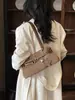 Bolso tipo baguette de un solo hombro con diseño de nicho estilo coreano y decoración de cinturón, nuevo y moderno bolso para el antebrazo, bolso de mano y bolso cruzado versátil para mujer