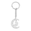 Fabricantes de pequeñas joyas de Yiwu, llavero de acero inoxidable con colgante de luna con patrón vacío y diseño de conejo saltador.