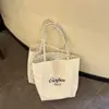 Bolsa de Lona 2026 Off-White Bolinhas Novo Estilo Estilo Coreano Ombro Único Versátil Dupla Face Para Ir ao Trabalho Passeio Bolsa Grande Capacidade