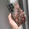 Bestseller de comercio electrónico transfronterizo: Funda rígida de cristal para Samsung S22/S23 Ultra con diseño artístico floral de polvo dorado