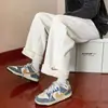 Pantalones deportivos de punto gofre al por mayor para hombre, pantalones gruesos forrados de forro polar de lana de cordero para otoño e invierno, pantalones holgados de pierna ancha rectos