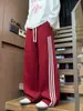 Calça de moletom casual patchwork listrada estilo americano para homens, corte clean, calça esportiva de perna reta solta, calça de perna larga color-block para o outono