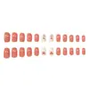 Modelo Más Vendido de Comercio Exterior: Uñas Postizas Rectangulares de Longitud Media, 24 Piezas, Diseño de Hoja Naranja Cálida con Forma de Corazón para Otoño e Invierno, Suaves y Dulces, Venta al por Mayor