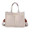 Bolso bandolera de lona con asa superior y múltiples compartimentos de Amazon DOURR, bolso pequeño para mujer.