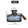 Botellas de aromaterapia vacías de alta gama al por mayor, difusores sin llama de ratán y flores secas, alto valor estético con tapa, color gris ahumado