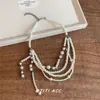 Collar de perlas con borlas multicapa y diseño en capas, cadena única y exagerada para la clavícula, sensación de lujo ligero y alta gama para mujeres