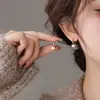 Aretes de hoja de plata 999 con aguja, cuidado de perforación de oreja, no es necesario quitárselos al dormir, nuevos aretes populares de nicho 2026 para mujer