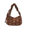 Bolsa de axila estampada de alta qualidade para mulheres, um novo estilo transfronteiriço com um design de laço fresco e delicado, uma bolsa de ombro chique e estilosa, e uma bolsa de mão única.