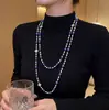 Elegante collar largo de perlas estilo coreano para mujer, versátil para otoño e invierno, exquisita cadena para suéter, colgante de letra simple y único, venta al por mayor