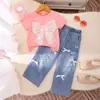 Exportação Transfronteiriça Conjunto Infantil Verão Estilo Europeu e Americano Camiseta Manga Curta com Laço para Meninas Calça Jeans Rasgada Conjunto de Duas Peças