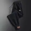 Pantalones casuales al por mayor para hombre otoño e invierno forrados de polar engrosados pantalones deportivos para hombre pantalones de punta suelta una generación de pelo
