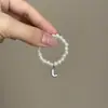 Mini Labubu Cuarta Generación Caja Sorpresa Ropa de Muñeca Collar Colgante Labubu 26 Letras Collar de Perlas Accesorios de Joyería