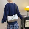 Bolsas Pequenas para Homens e Mulheres 2025 Primavera Nova Moda Estilo Coreano Bolsa de Ombro Único Transversal Bolsa Quadrada Pequena de Lona com Bloqueio de Cor Estudante Tendência