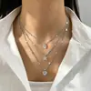 Collar Clavícula Retro Francés de Imitación Perla con Borla de Corazón de Tres Capas Apilable Europeo y Americano Nicho Temperamento de Gama Alta para Mujeres