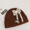 Gorro de punto estilo coreano de mezcla de lana inspirado en la dopamina con un lazo, un gorro de invierno cálido y protector para las orejas para mujer, adecuado para estudiantes