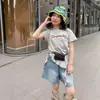 Camiseta de Manga Corta Irregular de Dibujos Animados Estilo Coreano para Niñas Tallas Mediana y Grande Verano 2026 Nuevo Top Elegante y Moderno para Niños