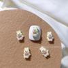 Celebridad popular en línea caricatura Oso de peluche marrón accesorios para uñas garra de gato lazo flor conejo taladro de uñas al por mayor