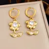 Pendientes retro de otoño/invierno pequeños y florales de color dorado más vendidos transfronterizos para mujer, con un diseño delicado y elegante con flores incrustadas de diamantes, y fabricados en acero inoxidable