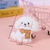 Nueva Familia de Perros Cachorros de Dibujos Animados Bufanda Corbata de Moño Accesorios para Muñecas Decoración de Bolsos Accesorios DIY Colgante Venta al por Mayor
