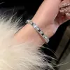 Pulsera Trenzada Hebilla de Herradura Redonda de Circonita Roja Europea y Americana Diseño de Nicho Pulsera Exquisita de Gama Alta para Mujer