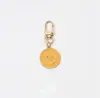 Llavero de cara sonriente de color aleación con goteo transfronterizo de comercio electrónico, accesorios de colgante para bolso con expresión irregular chapado en oro