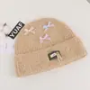 Gorro de punto estilo coreano, mezcla de lana, inspirado en la dopamina, con un lazo, diseñado para mujeres, que proporciona calidez y protección para los oídos en otoño e invierno, adecuado para estudiantes