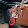 Llavero Ojo de Demonio de Aleación Hueca con Pedrería Cordón de Cuero Trenzado Colgante Ojo Turquesa Encanto para Bolsa Venta al por Mayor