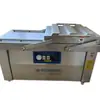 Máquina de envasado al vacío para salchicha de tocino de doble cámara máquina de sellado al vacío para pollo estofado pollo estofado máquina de envasado para pasteles de arroz de doble propósito para seco y húmedo