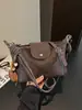 A bolsa de dumpling trançada popular deste ano para mulheres é a nova bolsa de ombro simples da moda de 2026, uma bolsa transversal de nicho estilo coreano