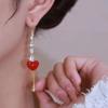 Líneas de oreja de borla de amor rojo 2023 nuevo moderno de alta gama lujo ligero largo cara redonda elegante pendientes elegantes para mujeres