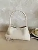 Bolso de mano tejido de nicho coreano para mujer, moda retro casual de moda nuevo otoño 2026, bolso de hombro bajo el brazo