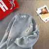 Marca de moda de calle estadounidense suéter de punto con cuello redondo desgarrado para hombre y mujer, cárdigan de otoño e invierno, chaqueta de punto casual versátil