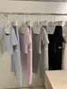 Wgwe9829 Guangzhou Shisanxing Roupa Feminina Verão 2026 Novo Conjunto de Blusa de Gola Redonda Slim Fit e Calça Casual Reta