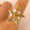 Anel de Aço Inoxidável com Pérola de Zircônia Estilo Oceano Cruzado Europeu e Americano Anel de Estrela do Mar Concha Búzio Joia de Mão Elegante para Mulheres