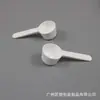 Suministro Directo de Fábrica de Cuchara Desechable para Crema Facial, Cuchara de Media Luna, Palillo para Ajuste de Película, Cuchara Cosmética de Plástico, Cuchara para Mascarilla Facial