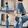 Jeans anchos de tiro bajo rasgados estilo americano para mujer, nuevo súper popular otoño 2026 control de abdomen ajuste ancho pantalones de pierna ancha hasta el suelo desgastados