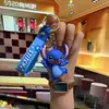 Nuevo Llavero de Muñeco Rígido Feliz Lindo Colgante Creativo para Mochila Llavero de Coche Regalo de Graduación