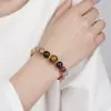 2025 Nuevo Pulsera de Cristal Súper Siete Negro Dorado Natural Flor de Flor de Pegamento de Cristal Torre Amarilla Flor de Pegamento Rojo para Hombres y Mujeres