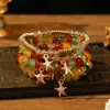 Pulseras multicapa al por mayor, juego de cuatro piezas de joyería con cuentas de artesanía en vidrio, juego de pulseras elásticas, accesorio de mano con soporte de flor de hierro