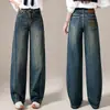 Jeans vintage de tiro alto, pierna ancha, color azul oscuro para mujer, con lavado desgastado, diseño de abertura, efecto adelgazante y silueta fluida de pierna recta.